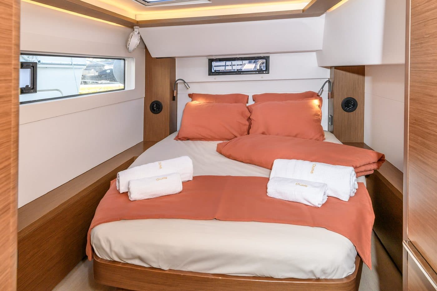 Guest cabin with coral linen and ambient lighting