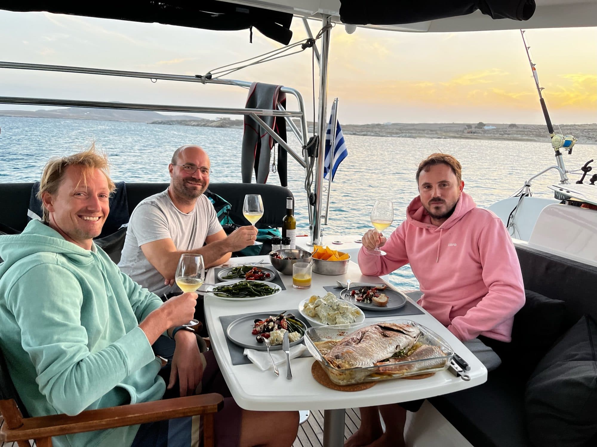 Guests dining in the cockpit at sunset