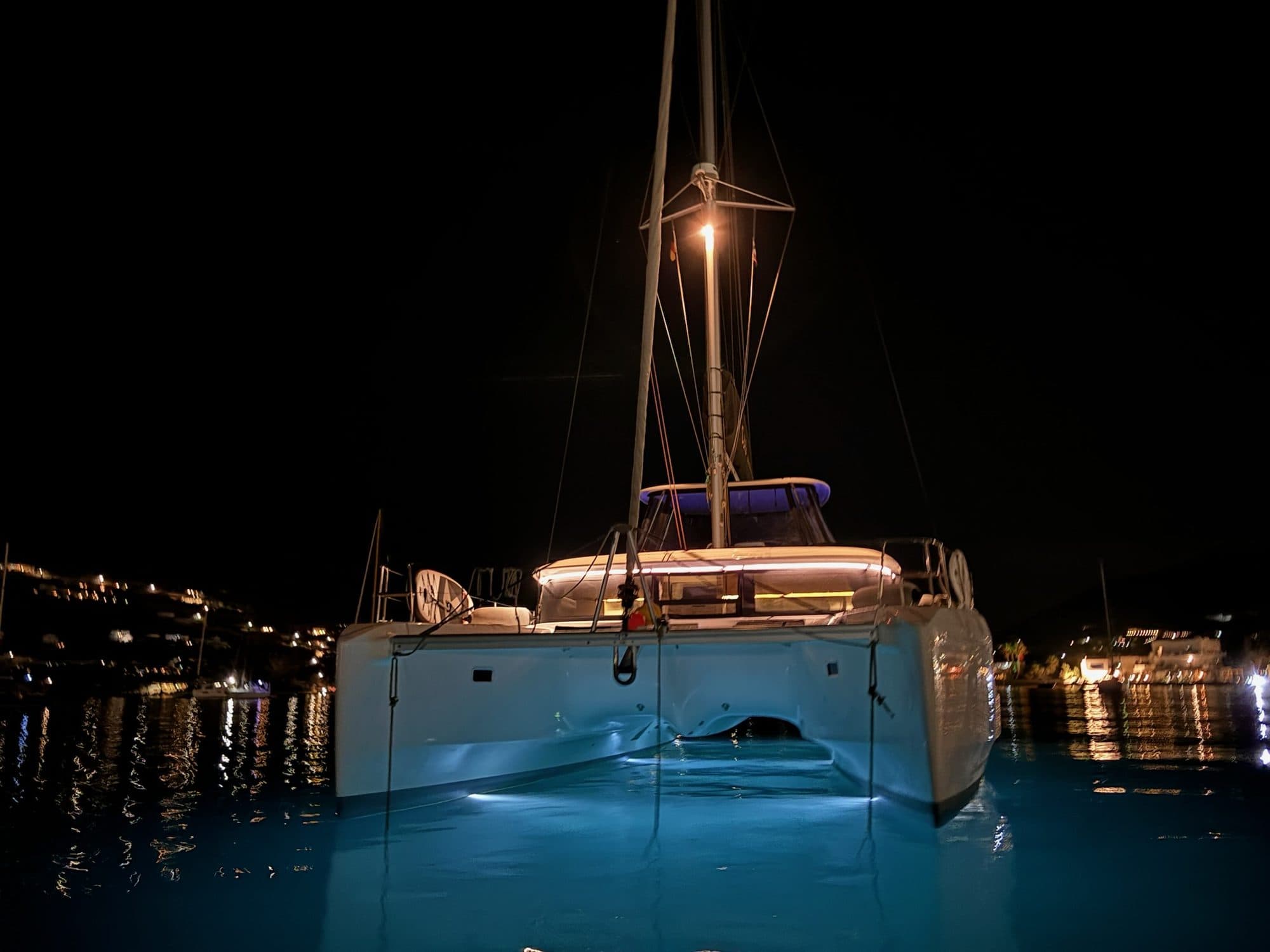 Ouna lit at anchor under a still night